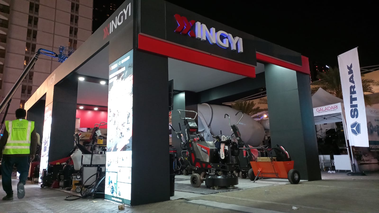 Maeander team member beside a machinery exhibition stand during installation in the UAE